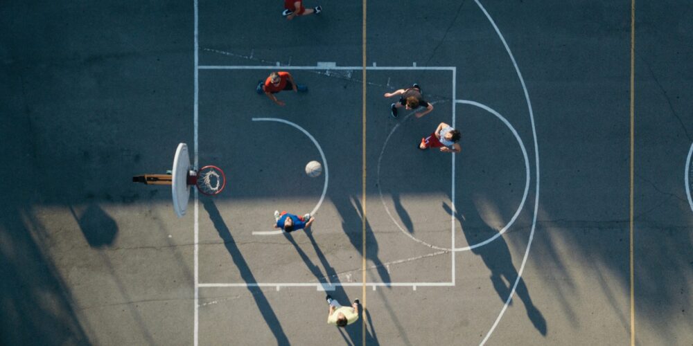 Overhead view of friends on basketball court playing basketball game