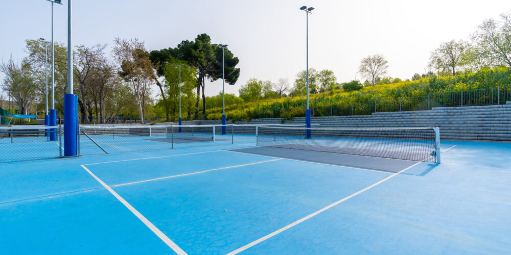 Sunny day in pickleball outdoors blue court with no people around